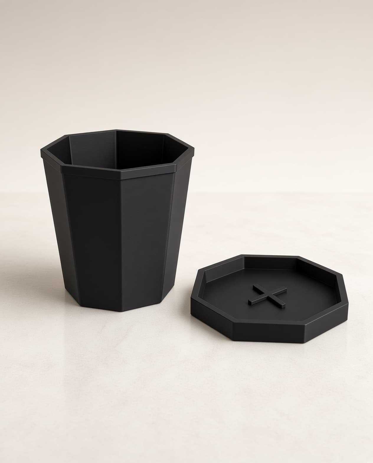 Empty geometric planter beside matching saucer, no plant