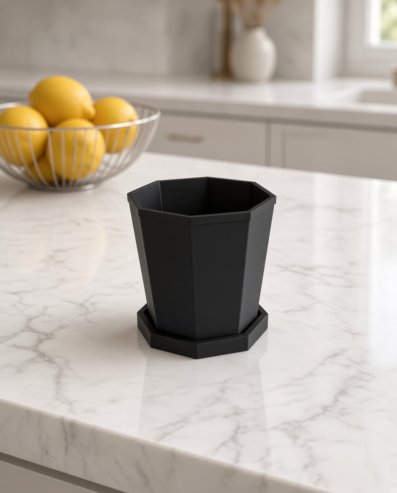 Empty geometric planter and saucer on a marble counter