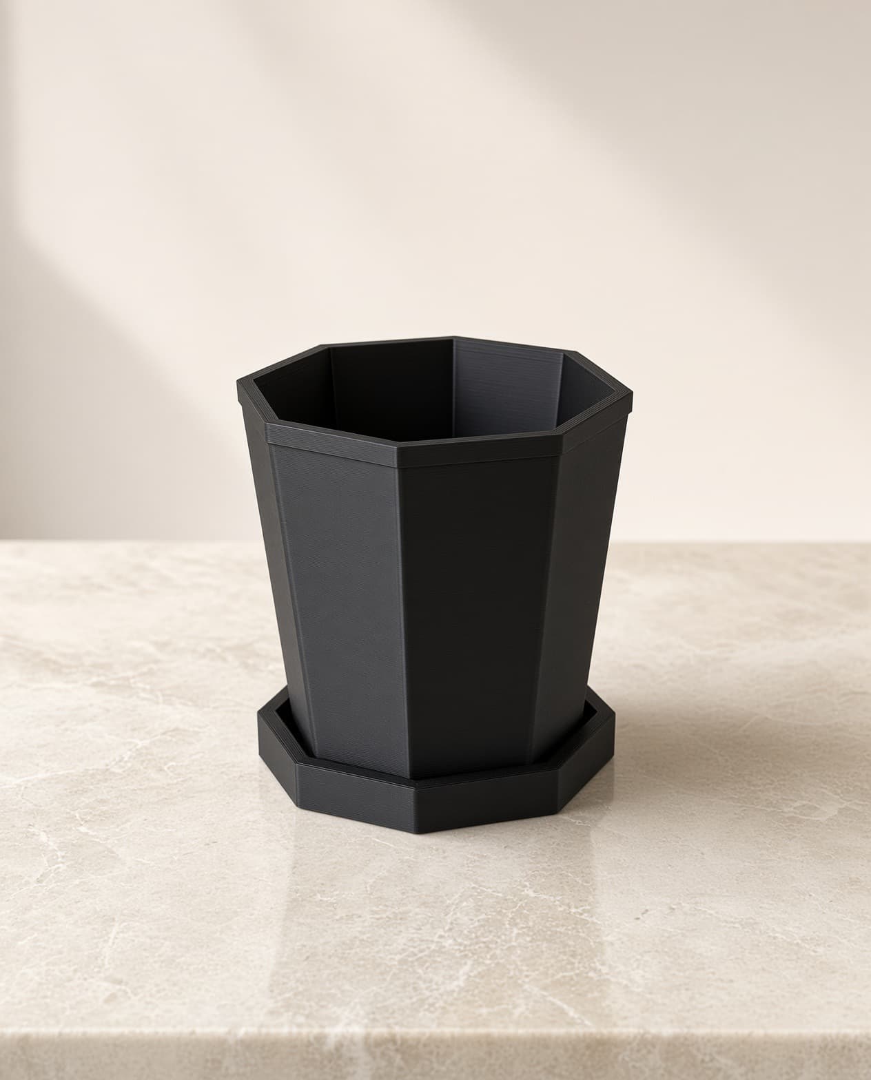 Empty geometric planter on matching saucer